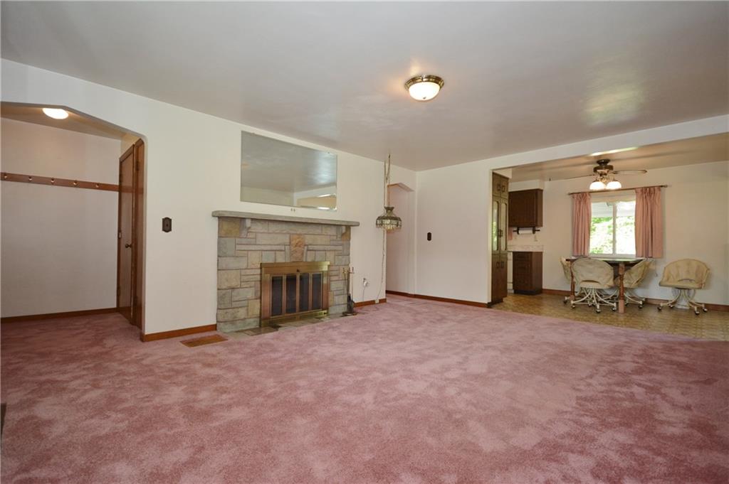 1034 Silver Lane McKees Rocks, PA 15136 - Photo 4 of 25 Opposite angle view of the living room showing the front entry on the left, hallway leading to the two main level bedrooms and full bath at the center, and dining area of the kitchen on the right.