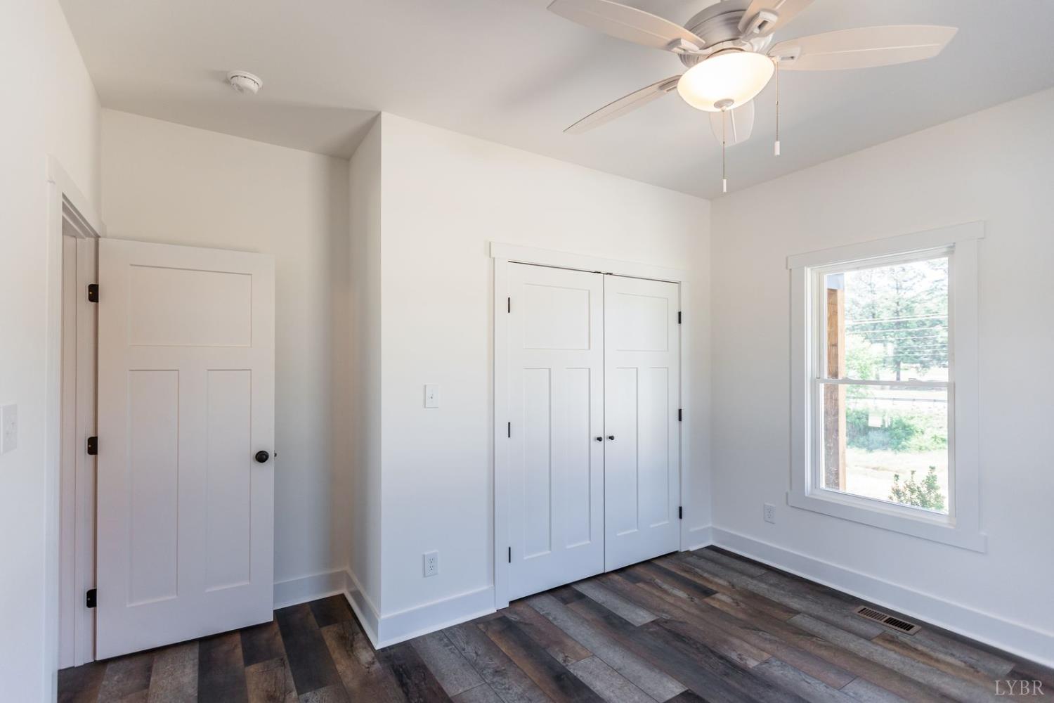 9740 Oakville Road Gladstone, VA 24553 - Photo 58 of 75 a view of an empty room with wooden floor and a window