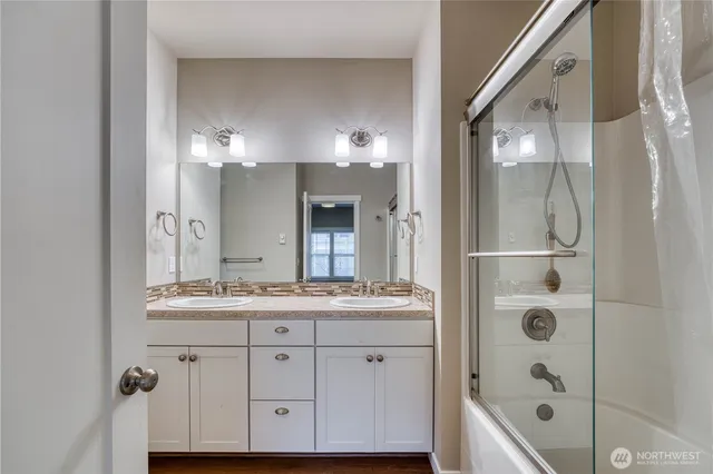 a bathroom with a double vanity sink and mirror