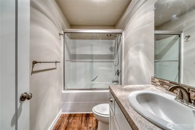 a bathroom with a sink toilet and shower