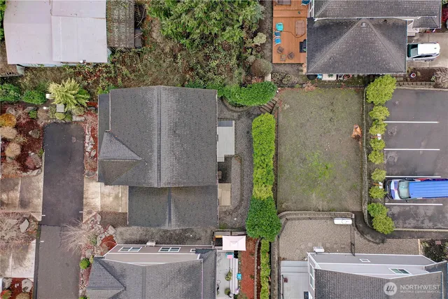 an aerial view of a house with a yard basket ball court and outdoor seating
