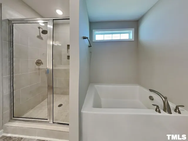 a bathroom with a tub and shower