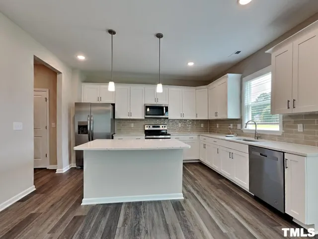 a large kitchen with stainless steel appliances kitchen island a large island in the center