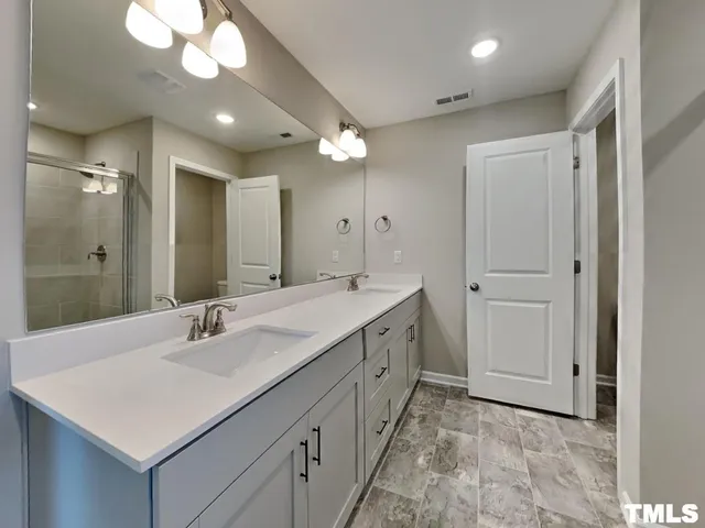 a bathroom with a sink vanity and a mirror