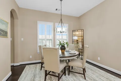 a large kitchen with a table and chairs