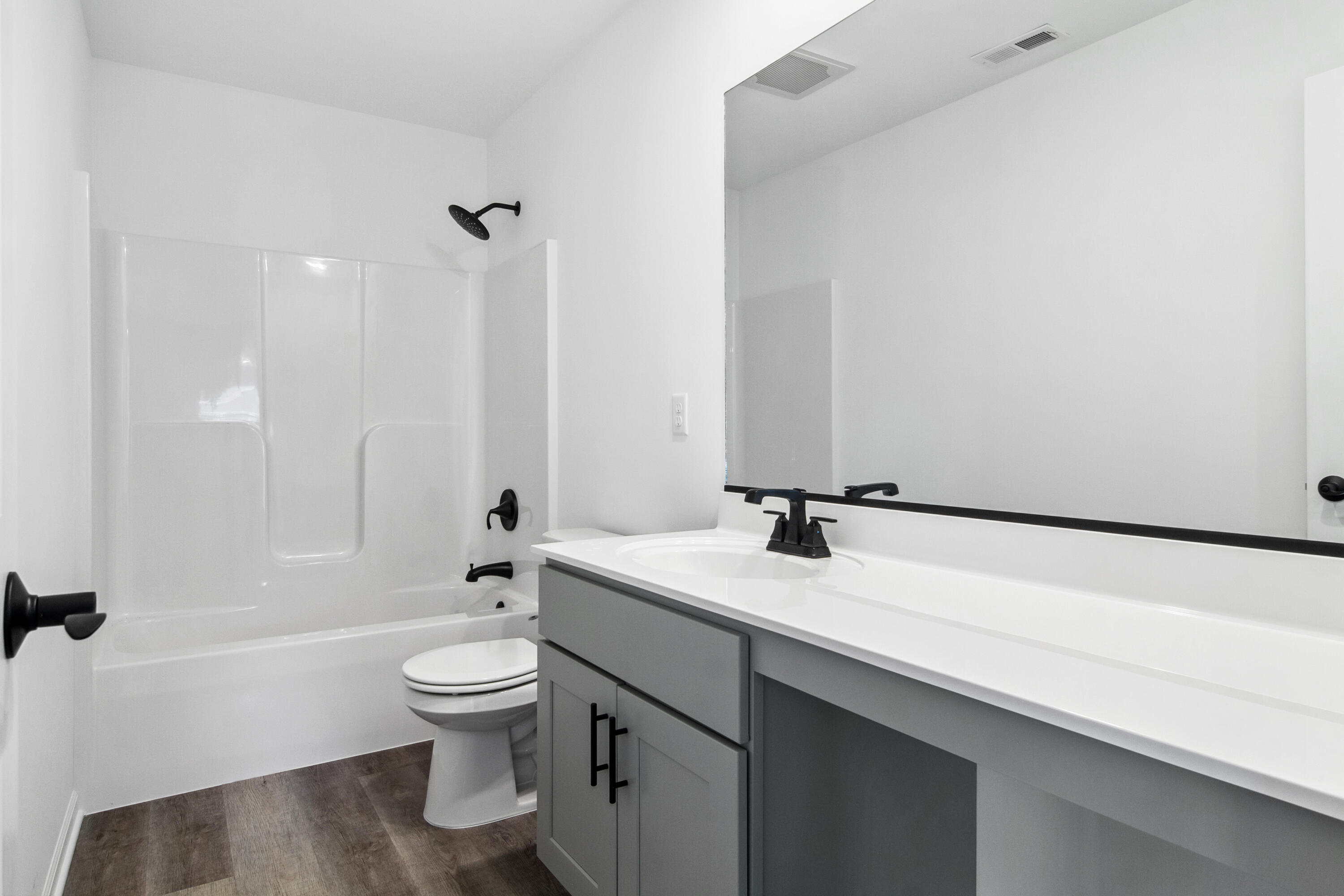 10340 California Street Crown Point, IN 46307 - Photo 18 of 22 a bathroom with a granite countertop sink a toilet and a large mirror