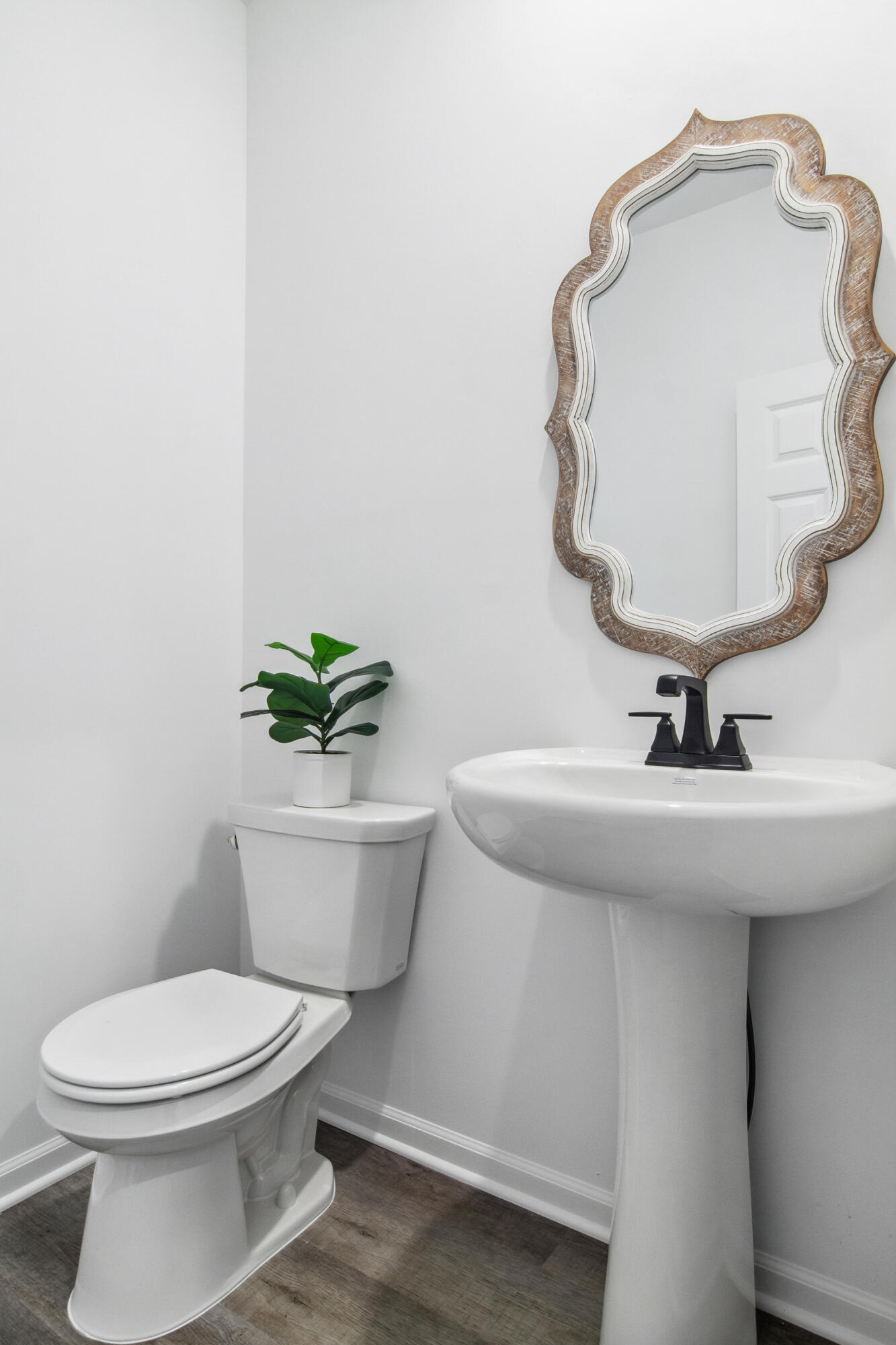 10340 California Street Crown Point, IN 46307 - Photo 8 of 22 a bathroom with a toilet a sink and mirror