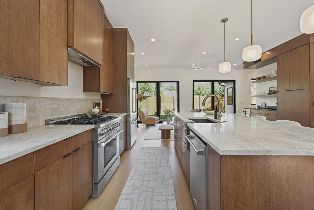 308 El Paso Street Austin, TX 78704 - Photo 12 of 38 a large kitchen with stainless steel appliances granite countertop a stove a sink dishwasher and a wooden cabinets