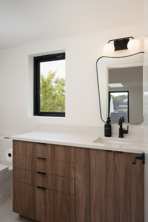 308 El Paso Street Austin, TX 78704 - Photo 36 of 38 a bathroom with a granite countertop sink and a mirror