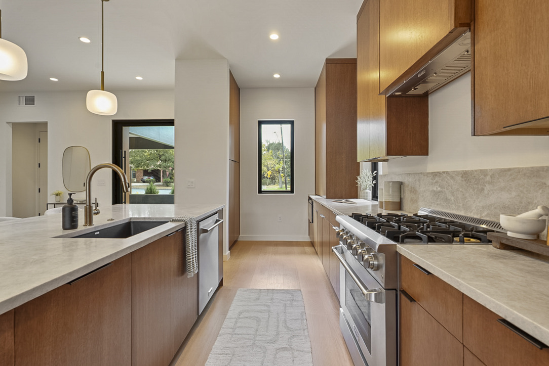 308 El Paso Street Austin, TX 78704 - Photo 8 of 38 a kitchen with stainless steel appliances a sink stove and cabinets