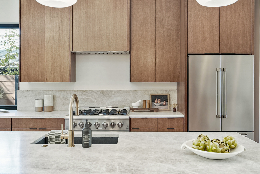 308 El Paso Street Austin, TX 78704 - Photo 10 of 38 a kitchen with stainless steel appliances granite countertop a sink a stove and a refrigerator with wooden floor