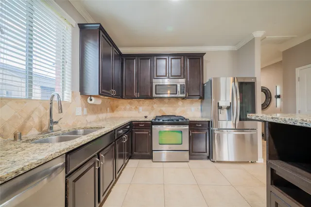 a kitchen with a refrigerator sink and microwave