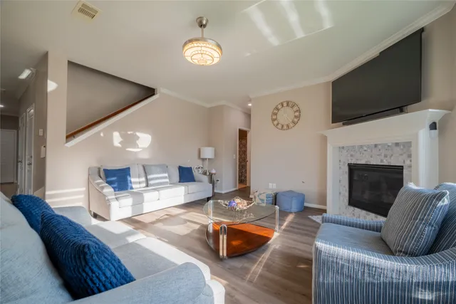 a living room with furniture fireplace and flat screen tv