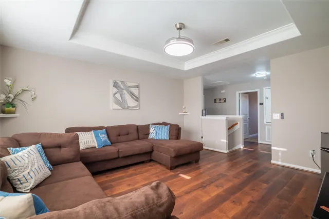 a living room with furniture and wooden floor