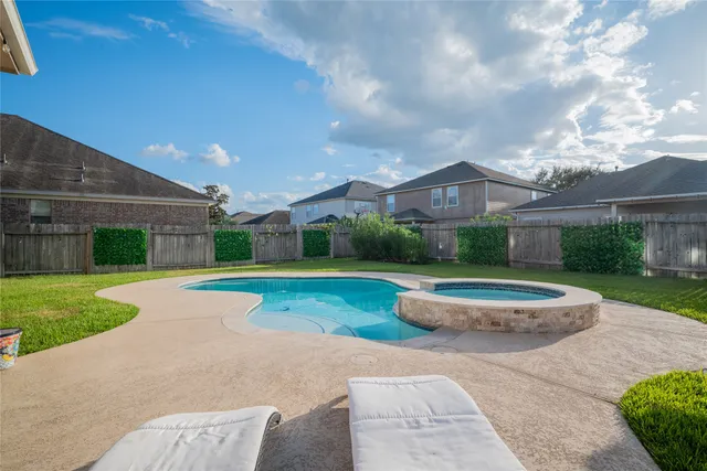 a view of a patio with table and chairs potted plants and a palm tree