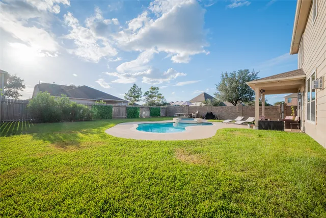 a view of a house with swimming pool and a yard