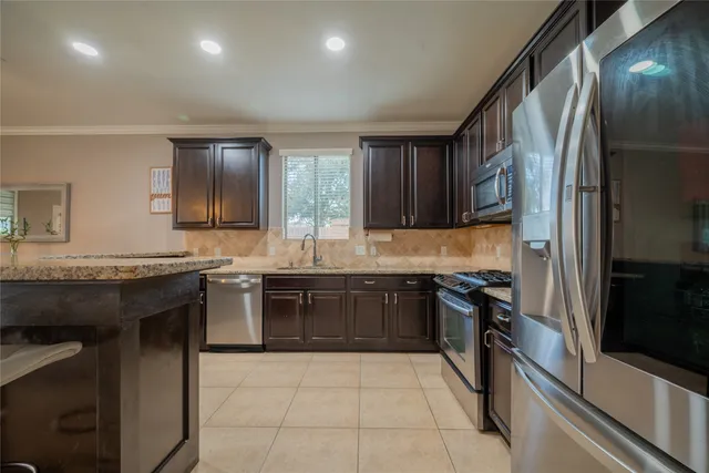 a kitchen with a sink stove and refrigerator