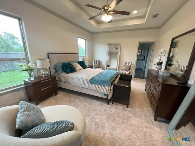 a bedroom with a bed couch and window