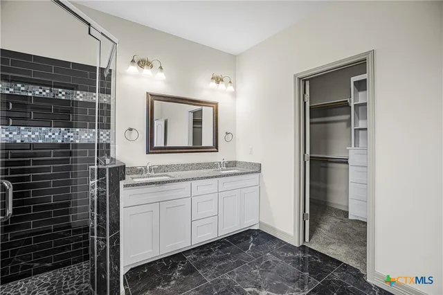 a bathroom with a double vanity sink and a mirror