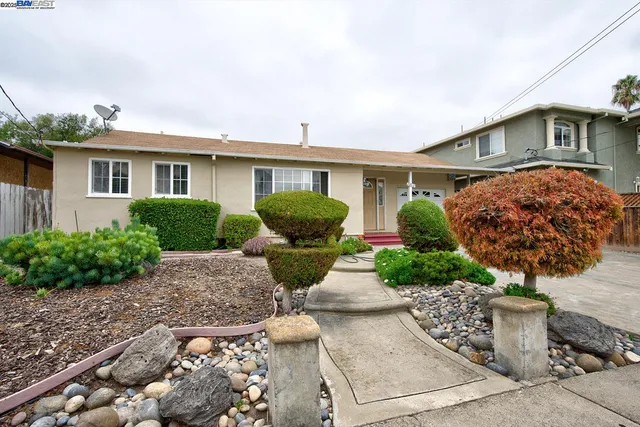 a front view of a house with garden