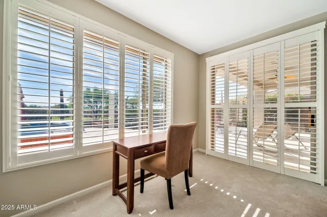 a view of a livingroom with furniture and a window