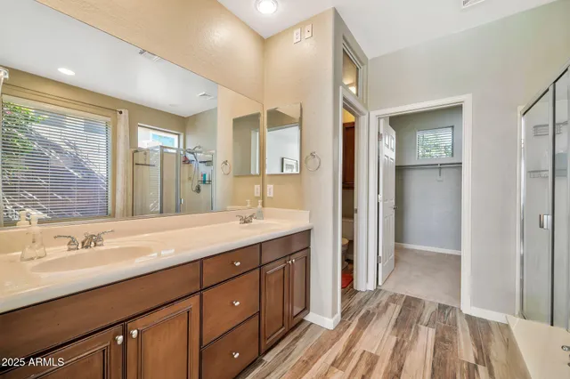 a bathroom with a sink a mirror and a shower