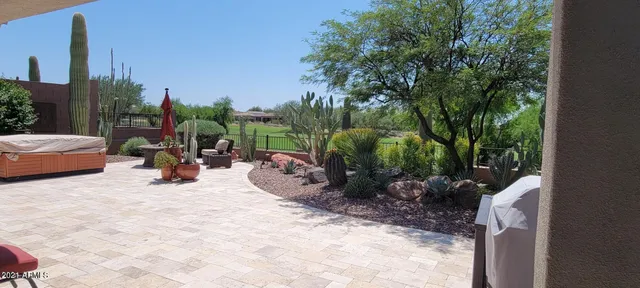 a view of a backyard with plants and a patio