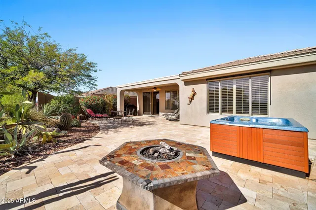 a view of a house with backyard outdoor seating area and furniture