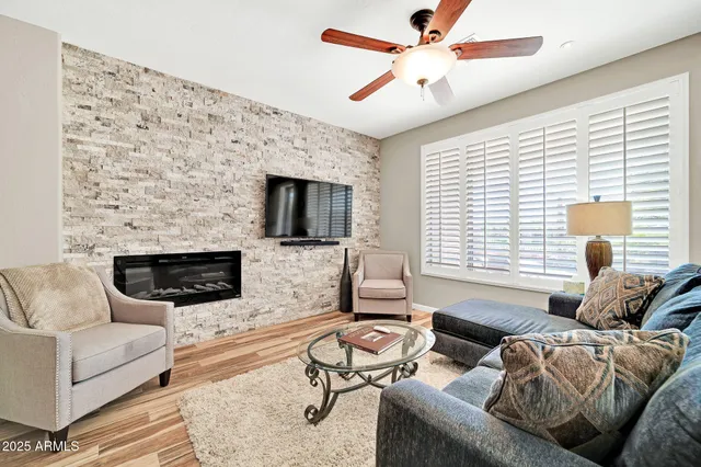 a living room with furniture a fireplace and a flat screen tv