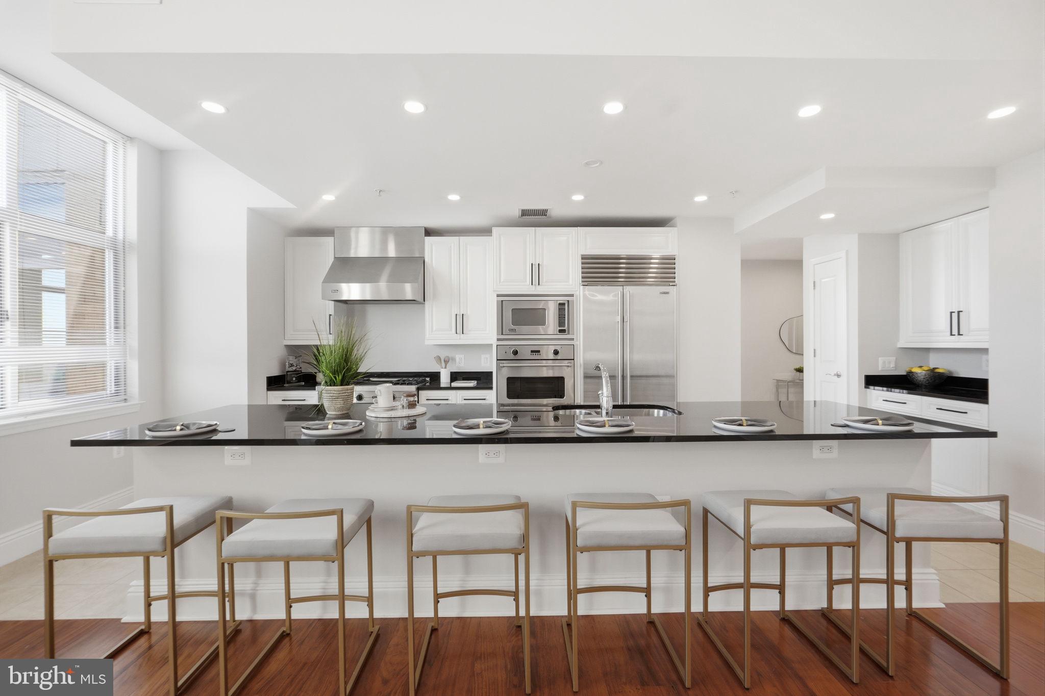 11990 Market Street, Unit 2103 Reston, VA 20190 - Photo 12 of 78 Sleek modern kitchen with elegant finishes.
