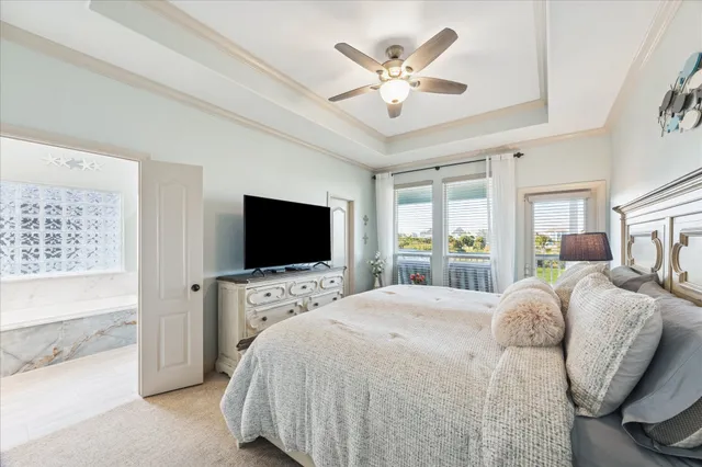 a spacious bedroom with a bed and a flat screen tv