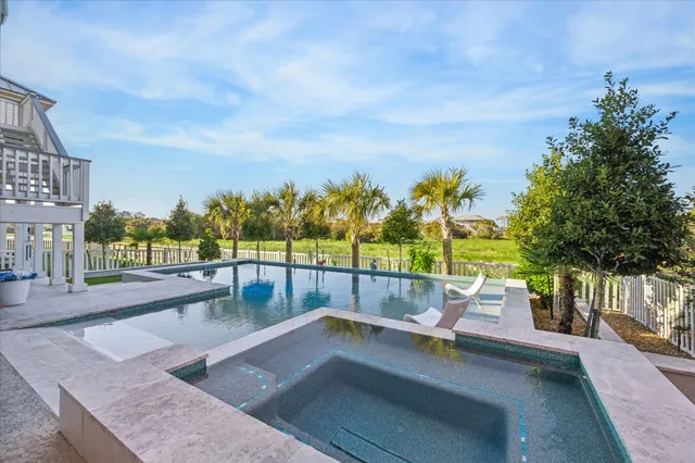 a view of swimming pool with outdoor seating and plants