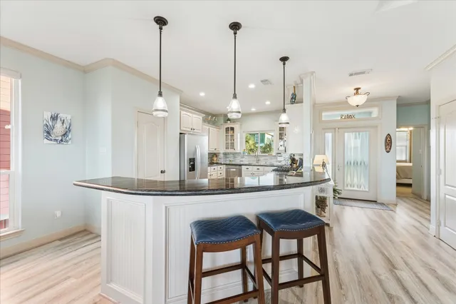a dining table chairs and a chandelier