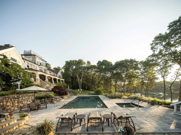 a view of swimming pool with outdoor seating and a pathway