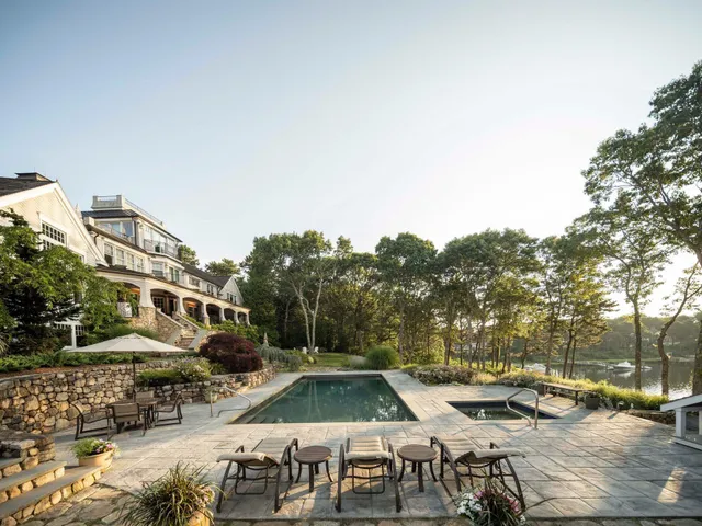 a view of swimming pool with outdoor seating and a pathway