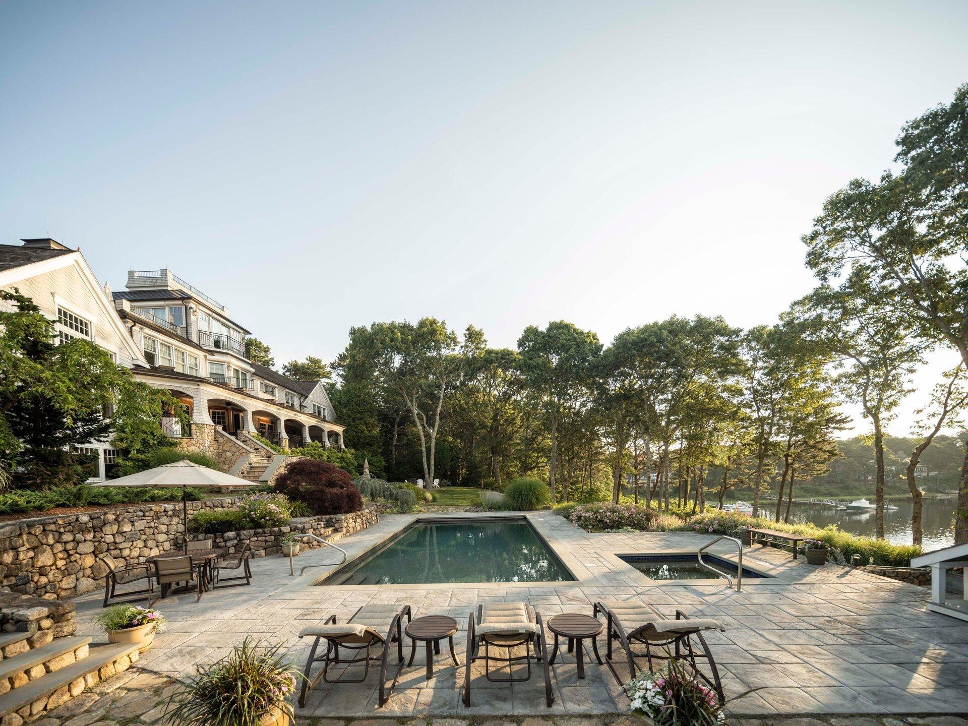 a view of swimming pool with outdoor seating and a pathway
