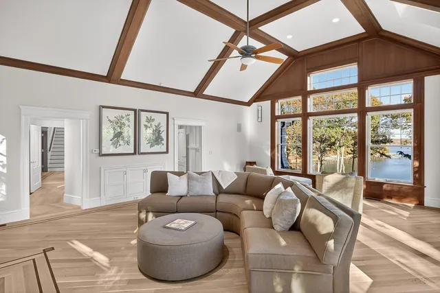 a view of a hallway with wooden floor and closet