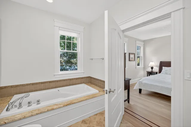 a living room with furniture tv and large windows