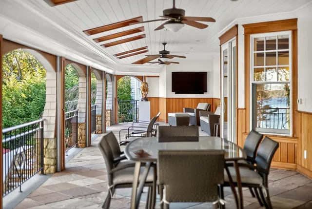 a living room with furniture and large windows