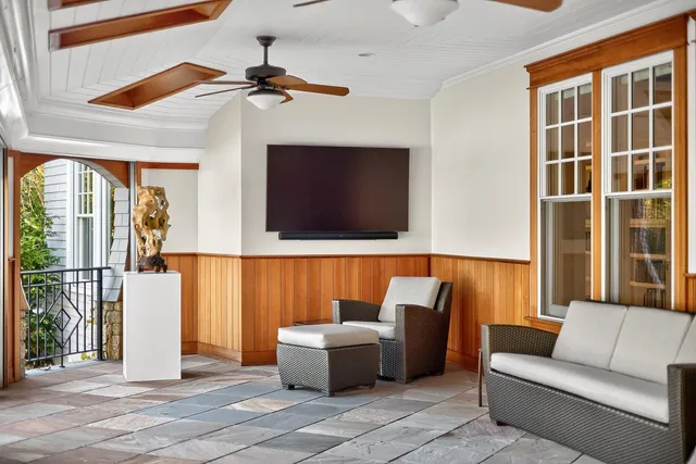 a living room with furniture and large windows