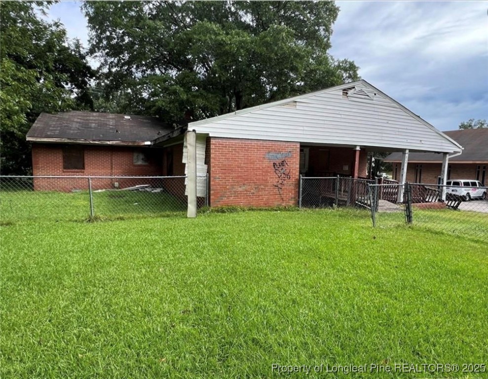 a front view of house with a garden