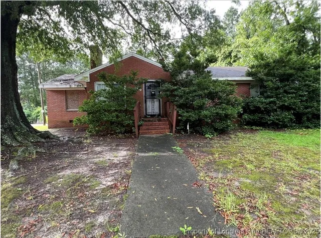 a view of a backyard with plants and patio