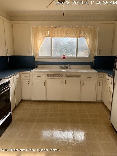 28 Yellowbrook Road Freehold, NJ 07728 - Photo 3 of 9 a kitchen with a stove and a white cabinet