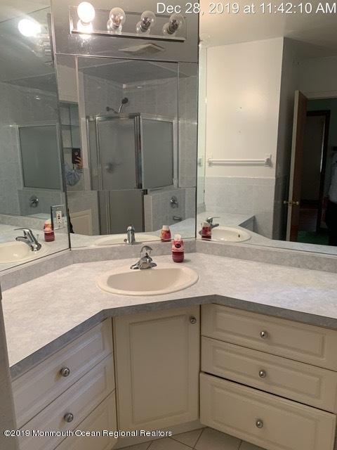 28 Yellowbrook Road Freehold, NJ 07728 - Photo 8 of 9 a bathroom with a sink and a mirror