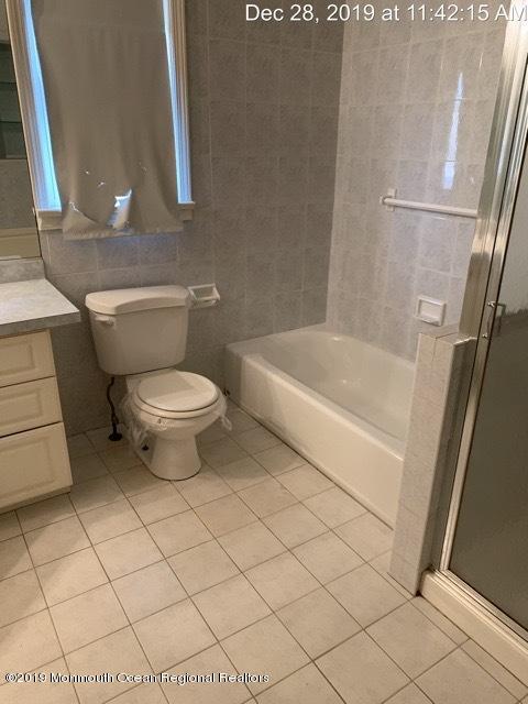28 Yellowbrook Road Freehold, NJ 07728 - Photo 9 of 9 a white toilet sitting next to a bath tub