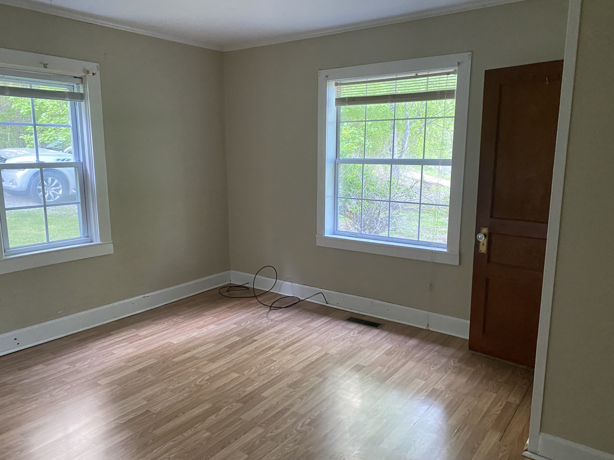 1025 Chandler Road Ashland City, TN 37015 - Photo 5 of 12 a view of an empty room with wooden floor and a window