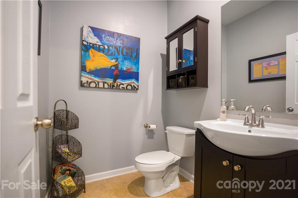 2714 Aldergrove Road Matthews, NC 28105 - Photo 11 of 23 a bathroom with a toilet a sink and mirror