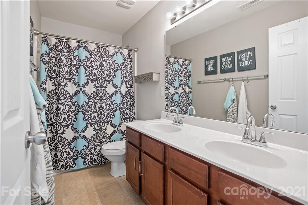 2714 Aldergrove Road Matthews, NC 28105 - Photo 16 of 23 a bathroom with a sink toilet and shower