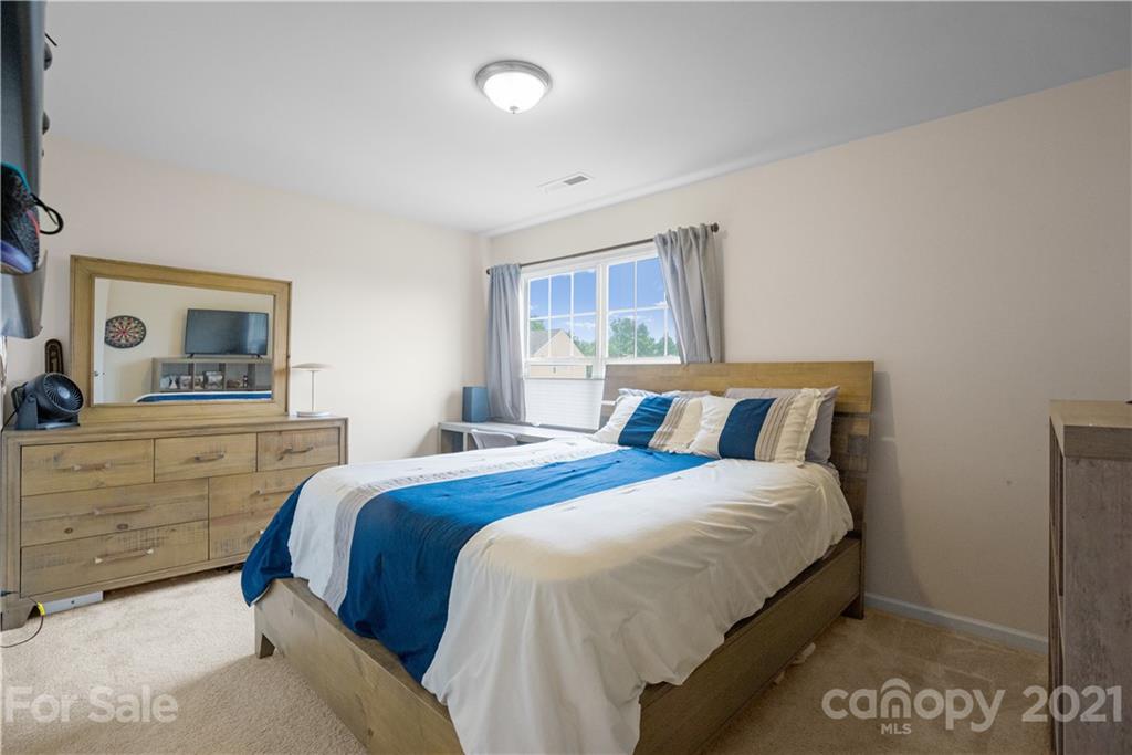 2714 Aldergrove Road Matthews, NC 28105 - Photo 17 of 23 a bedroom with a bed and a dresser