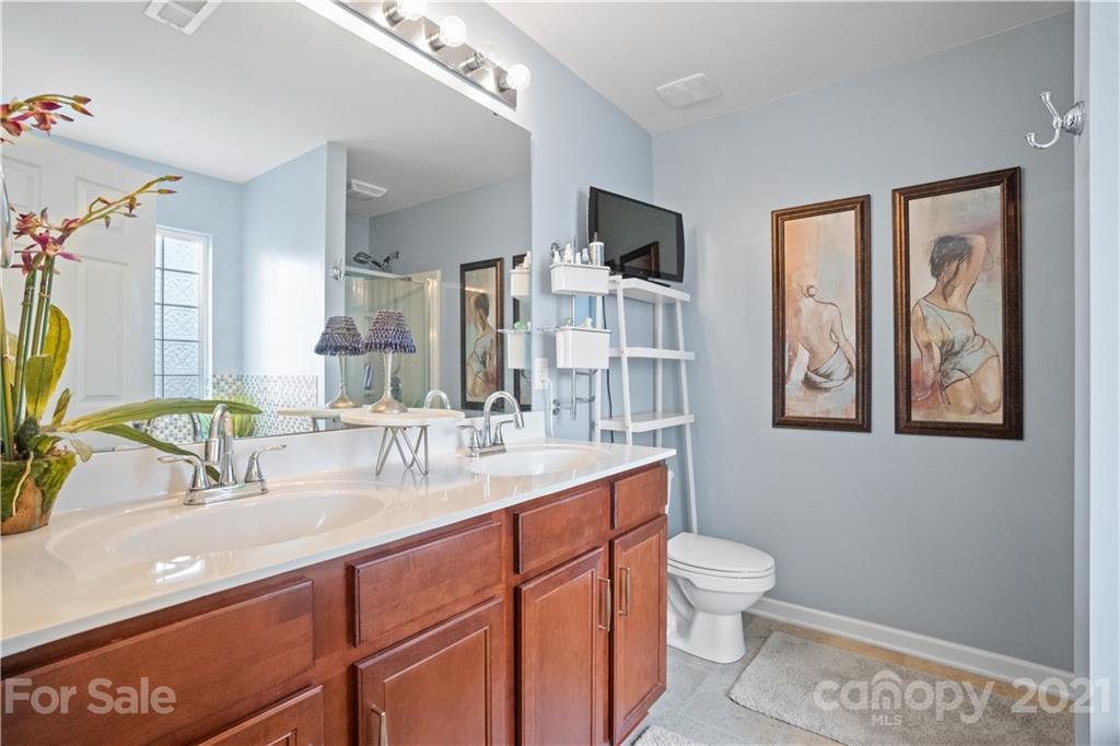 2714 Aldergrove Road Matthews, NC 28105 - Photo 20 of 23 a bathroom with a toilet sink and mirror